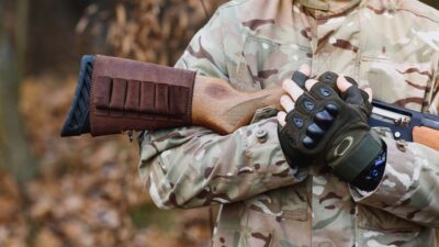 Hunting equipment. Brutal masculine hobby. Man observing nature background.