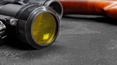 Optical sight of hunting rifle on grey background