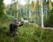 Hunter aiming with weapon at the outdoor hunting