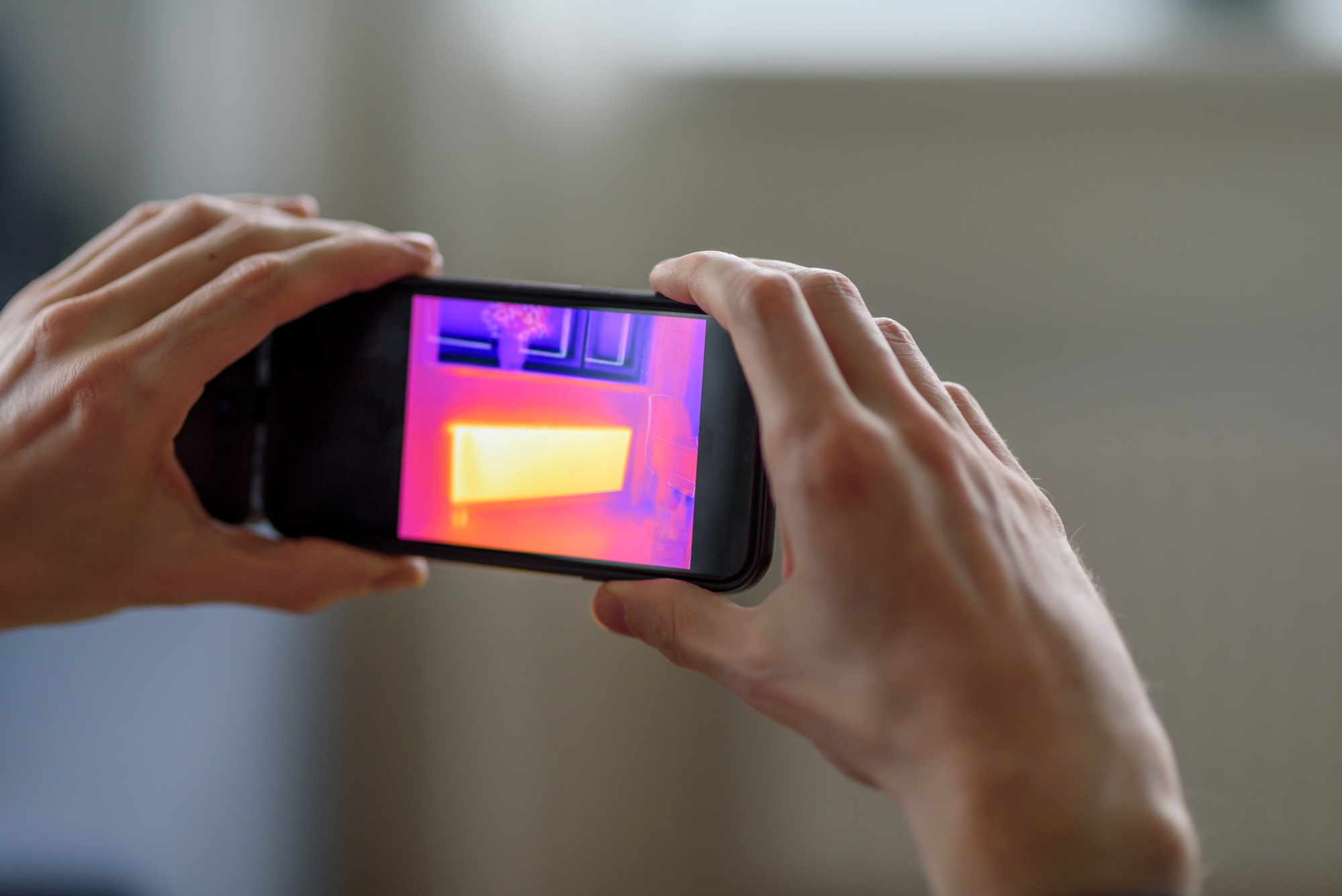 Person doing thermal scanning of apartment
